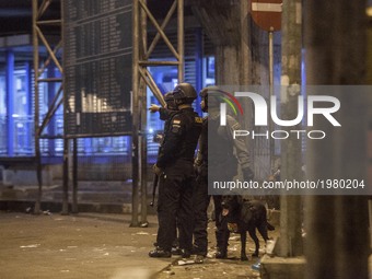 Police officers search for dangerous material in the site of bomb exploison at Kampung Melayu bus station, Jakarta, Indonesia, on May 24, 20...