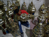 A Palestinian vendor sells traditional lanterns known in Arabic as 