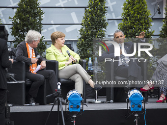 Former US President Barack Obama (C-R) and German Chancellor Angela Merkel (C-L) attend a panel discussion about democracy at the Protestant...