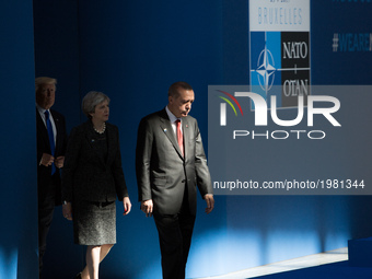 Turkish President Recep Tayyip Erdogan, Britain's Prime Minister Theresa May (C) and US President Donald Trump (L) arrive to the NATO (North...
