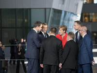 German Chancellor Angela Merkel (C) takes part in the NATO (North Atlantic Treaty Organization) summit at the NATO headquarters, in Brussels...