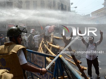 Indian police fire water cannons to disperse the Bharatiya Janata Party activists during their march to the police headquarters in Kolkata,...