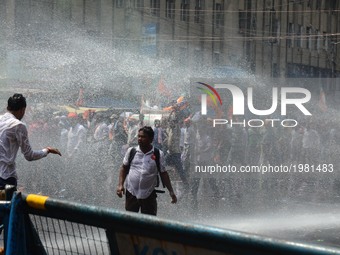 Indian police fire water cannons to disperse the Bharatiya Janata Party activists during their march to the police headquarters in Kolkata,...