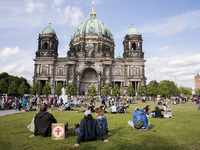 People and tourists enjoy the sun at the Lustgarten in front Berlin's Dome in Berlin, Germany on May 25, 2017. (