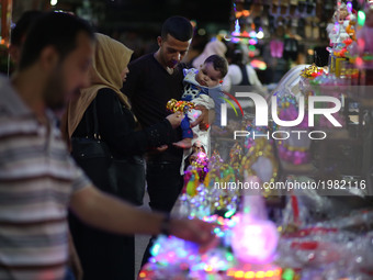 Palestinians shop at a market traditional lanterns known in Arabic as 