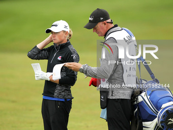 Stacy Lewis of the United States and caddie wait in the fairway of the 18th hole during the first round of the LPGA Volvik Championship at T...