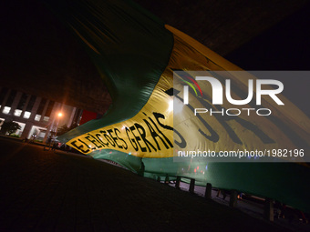 Demonstrators unfurl a huge flag reading 'General elections now!' during a protest against the government of president Michel Temer and to d...
