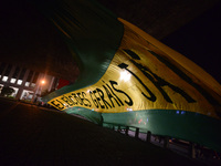 Demonstrators unfurl a huge flag reading 'General elections now!' during a protest against the government of president Michel Temer and to d...