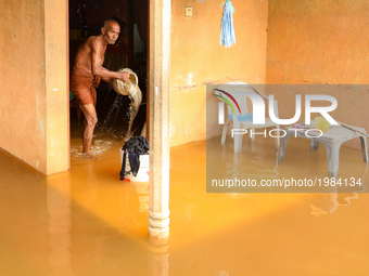 A Sri Lankan man cleans his house  inundated  by flood water  at Kaduwela, 20kms away from capital city Colombo, Sri Lanka. Friday 26th  May...