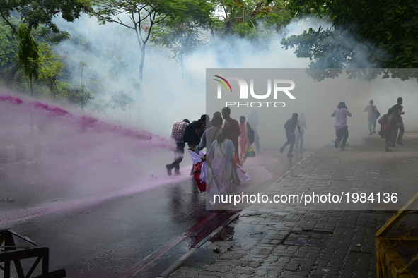 Bangladeshi policeman lob several tear gas canisters and use water cannons to disperse activists protesting against the removal of a Lady Ju...