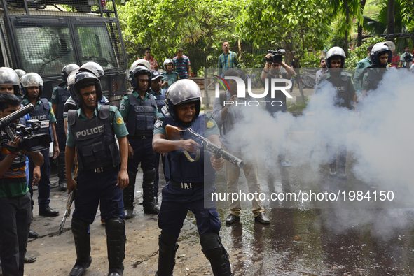 A Bangladeshi policeman shoots tear gas shells during a protest against the removal of a Lady Justice statue in Dhaka, Bangladesh, on May 26...