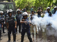 A Bangladeshi policeman shoots tear gas shells during a protest against the removal of a Lady Justice statue in Dhaka, Bangladesh, on May 26...