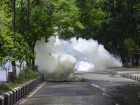 Bangladeshi policeman lob several tear gas canisters to disperse activists protesting against the removal of a Lady Justice statue in Dhaka,...