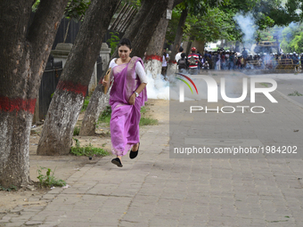 A Bangladeshi woman running in the street during a protest against the removal of a Lady Justice statue in Dhaka, Bangladesh, on May 26, 201...