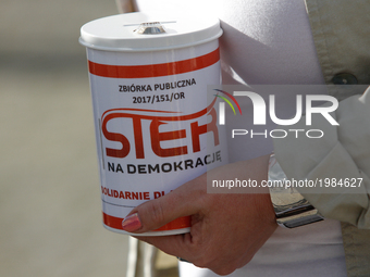 A woman is seen holding a can for collecting donations for the local organization for the protection of democracy and prevention of abuse of...