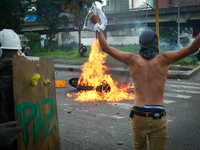 Anti-government protesters clash with security forces in Caracas, Venezuela, Friday, May 26, 2017. Venezuelans took to the streets in an att...