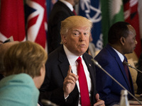 U.S. President Donald Trump (R) gestures towards German Chancellor Angela Merkel (L) during the G7 Summit expanded session in Taormina, Sici...