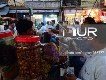 Indian muslims buy dates  on the first day of holy month of Ramadan ,at a street market , in Allahabad on May 27,2017. (