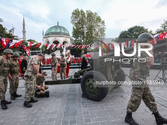 Turkish soldiers fire a military cannon to mark the fasting break time on  27 May 2017 at the Blue mosque square in Istanbul, during the fir...