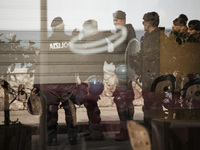 Italy, Taormina: anti riot policemen are seen reflected through a shop's window during the 'No G7' protest march at the G7 summit in Giardin...