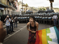 Italy, Taormina:  A demonstrator holds a rainbow flag during the 'No G7' protest march at the G7 summit in Giardini Naxos, near Taormina, Si...