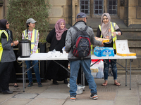 People, from the Myriad Foundation, hand out various foods and drinks for the homeless people of Manchester in Manchester, United Kingdom on...
