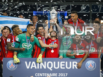 Paris Saint-Germain's Brazilian defender Maxwell (C) holds the trophy as he celebrates winning the French Cup final football match between P...