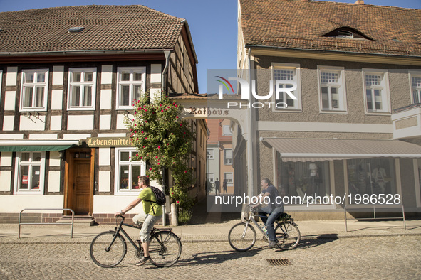 People ride by bike in a street in the city center of Luebbenau in the region of the Spreewald, Germany on May 27, 2017. 