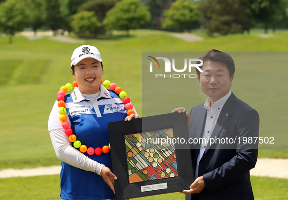Shanshan Feng of China and Kyung Ahn Moon, Chairman of Volvik INC pose for a photo after winning the Volvik Championship at Travis Pointe Co...