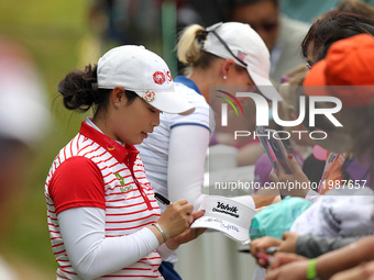 Moriya Jutanugarn of Thailand gives some autograp after finishing the final round of the LPGA Volvik Championship at Travis Pointe Country C...