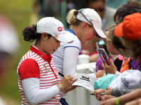 Moriya Jutanugarn of Thailand gives some autograp after finishing the final round of the LPGA Volvik Championship at Travis Pointe Country C...