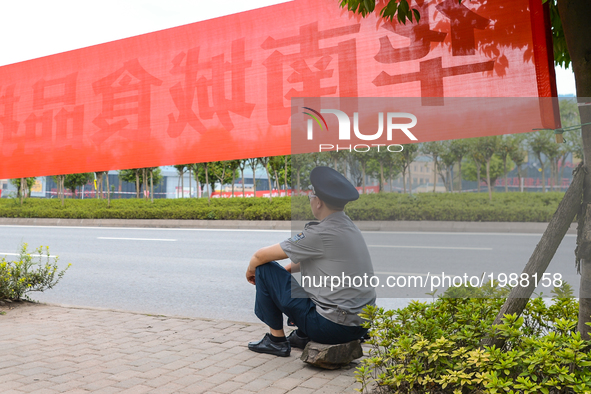 A local Policeman resting along the route in one of the suburbs of Chongqing (Population +8 Mln, Metro 52 Mln), one of China's four direct-c...