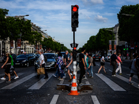 People are crossing champs elysees boulevard In Paris, France on May 28, 2017. Much of French people and tourists enjoyed hot and sunny weat...