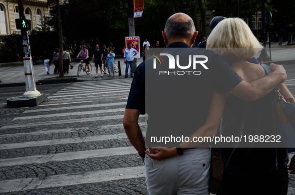 An older couple is crossing Champs Elysees boulevard in Paris, France on May 28, 2017. Much of French people and tourists enjoyed hot and su...