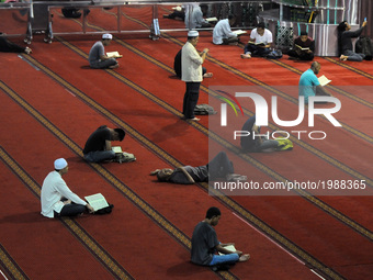 Indonesian Muslims read the Qur'an on the holiday of Ramadan in Istiqlal Great Mosque Jakarta, Indonesia, Sunday, May 28, 2017. During the m...