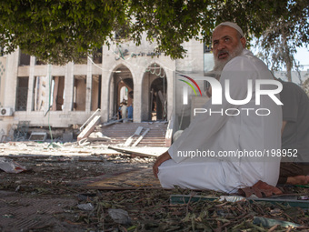 Palestinian men praying next to the Mosque of Al Ameen Mohammed destroyed by an Israeli strikes against in Gaza. (