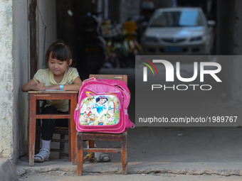 A child studies in the passage way outside her family home in Huangshi city center.
On Monday, September 19, 2016 in Huangshi, Yangxin Count...