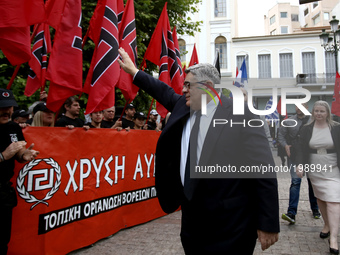 Golden Dawn leader Nikolaos Michaloliakos salutes party supporters arriving at a party  rally in central Athens on Monday May 29, 2017  to c...