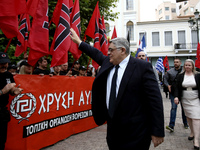 Golden Dawn leader Nikolaos Michaloliakos salutes party supporters arriving at a party  rally in central Athens on Monday May 29, 2017  to c...