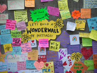 A peson leaves a message of support, as a tribute for the victims of the Manchester Arena attack, in Manchester, United Kingdom, Monday, May...