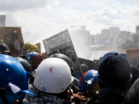 Opposition activists clash with the riot police as they block the Francisco Fajardo highway in Caracas during a demonstration against Presid...
