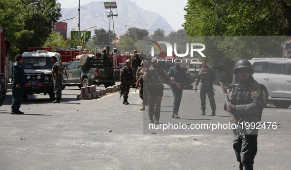 Afghan security forces members guard the site of a car bomb explosion in Kabul, capital of Afghanistan, May 31, 2017. At least 64 people wer...
