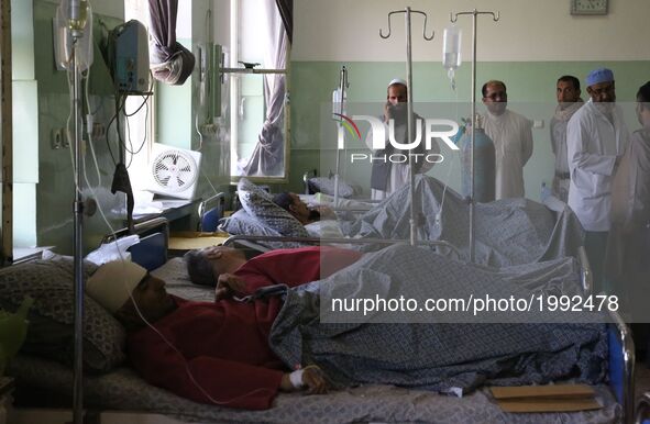 Injured men receive medical treatment at a hospital after a car bomb explosion in Kabul, capital of Afghanistan, May 31, 2017. The number of...