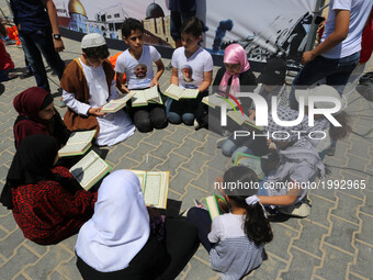 Palestinian children read copies of Koran during a rally to mark the 7th anniversary of the Mavi Marmara Gaza flotilla incident(