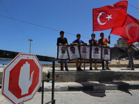 Palestinian children hold the Palestinian and Turkish flags and picture of activists who was dead by Israeli forces during a rally to mark t...