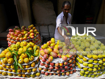 Indian mango fruit sealer wait for customers in the main wholesale market area of the city in Kolkata on June 1, 2017.  India's economic gro...