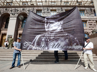 Protesters hold a portrait of military leader and general of the Ukrainian Insurgent Army (UPA) Roman Shukhevych. Activists and veterans of...