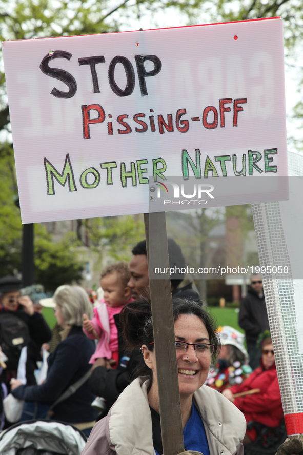 Demonstrator holds a sign saying 'stop pissing off mother nature' as hundreds of Canadians took part in a massive march against climate chan...