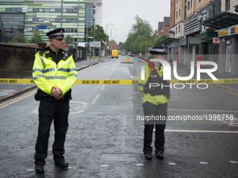 Police officers guard the cordoned off area of a street, where part of the investigation in to the Manchester Arena explosion is taking plac...