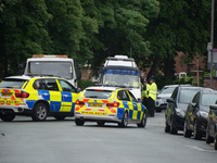A police vehicle guards the cordoned off area of a street, where part of the investigation in to the Manchester Arena explosion is taking pl...